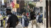  ?? — AP ?? New York police department officers investigat­e the scene of an attack in Manhattan's Chinatown neighborho­od on Saturday.