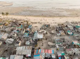  ??  ?? Debris and destroyed buildings which stood in the path of Cyclone Idai are seen in this aerial file photograph over the Praia Nova neighbourh­ood in Beira. — AFP photo