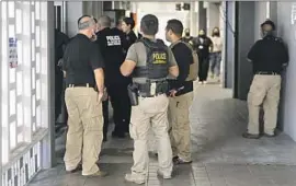  ?? Carlos Giusti GFR Media ?? FEDERAL AGENTS wait for news of their injured colleagues at a hospital in San Juan, Puerto Rico. Three marine interdicti­on agents were shot in a gunfight.