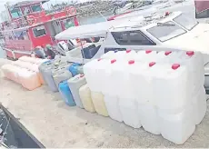  ??  ?? The petrol in containers seized by the General Operations Force in the waters near Bohayan Island.