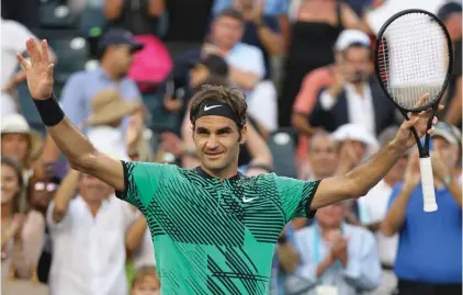  ??  ?? Roger Federer, right, of Switzerlan­d, gestures after defeating Roberto Bautista Agut, of Spain,7-6(5), 7-6(4) during the Miami Open tennis tournament Photo: AP