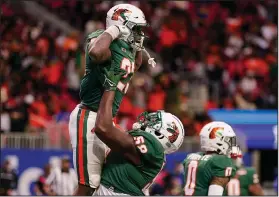  ?? Associated Press ?? Big score: Florida A&M running back Terrell Jennings (23) celebrates his touchdown against Howard during the Celebratio­n Bowl Saturday in Atlanta.