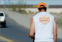  ?? Buy these photos at YumaSun.com PHOTOS BY RANDY HOEFT/YUMA SUN ?? WHAT DRIVES BUCKLEW IS CLEARLY STATED ON THE BACK of his shirt. Bucklew, from Wilmette, Ill., talks about his trek across the United States while standing at the intersecti­on of the North Frontage Road and Foothills Boulevard (left) on Thursday morning.