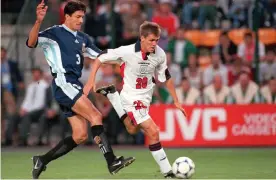  ??  ?? Michael Owen holds off José Chamot on his way to scoring his wonderful solo goal, one of the best moments English football has ever had. Photograph: Popperfoto/Getty Images