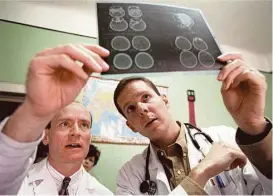  ?? Houston Chronicle file ?? Dr. Kline works with Baylor College of Medicine pediatrics resident Bryan Cannon during a trip to Romania in April 1998.