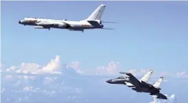  ?? (AP FOTO) ?? AIR PATROL. In this Sept. 25, 2016 file photo released by Xinhua News Agency, Chinese People’s Liberation Army Air Force Su-30 fighter (right) flies along with a H-6K bomber as they take part in a drill near the East China Sea. China patrolled the...