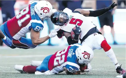  ?? JOHN MAHONEY ?? Alouettes Patrick Lavoie and Ryder Stone team up to take down Ottawa’s Loucheiz Purifoy during the first half of Friday’s game at Molson Stadium. The visiting Redblacks won 28-18 thanks to an offensive outburst in the first half, dropping Montreal’s...