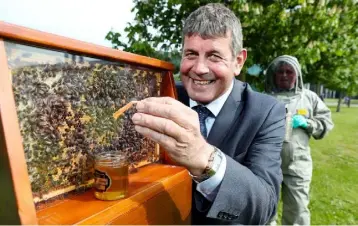 ??  ?? MINISTER of State at the Department of Agricultur­e, Food, and the Marine, Andrew Doyle, with the beehives installed at the Department’s Backweston Campus near Celbridge, Co Kildare in recognitio­n of World Bee Day.
The aim of World Bee Day, which took...
