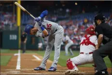  ?? MATT SLOCUM – THE ASSOCIATED PRESS ?? The Los Angeles Dodgers’ Cody Bellinger, left, dodges a pitch from Phillies starter Nick Pivetta during the first inning of a game July 17 at Citizens Bank Park. It would be Pivetta’s last start before being moved to the bullpen.