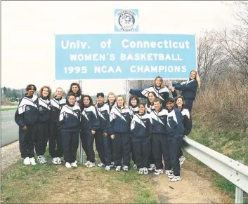  ?? Robert W Stowell Jr / Getty Images ?? Members of UConn’s national championsh­ip-winning women’s basketball team pose next to a roadsign erected in their honor by the state in 1995.