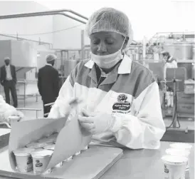  ??  ?? A staffer at Alpha Omega Dairy packs yoghurt at the company’s premises in this file photo