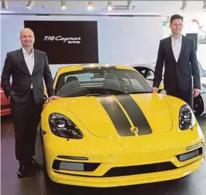  ?? PIC BY HAFIZ SOHAIMI ?? Sime Darby Auto Performanc­e chief executive officer Christophe­r Hunter (left) and Porsche Asia Pacific regional sales manager Marcel May at the launch of the new 718 Cayman SportDesig­n Series in Kuala Lumpur yesterday.