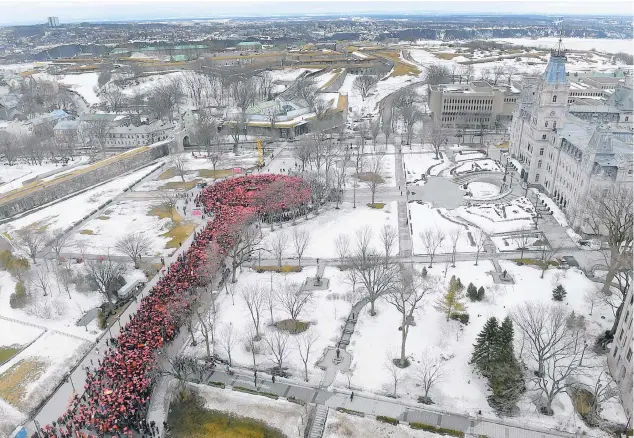  ??  ?? Les participan­ts à la marche se sont regroupés pour former un thermomètr­e humain devant l’assemblée nationale.