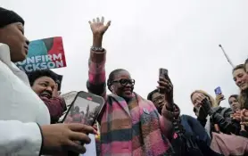  ?? Cheriss May, © The New York Times Co. ?? Regina Langley, from New Jersey, raises her hand as she and others watch Thursday in Washington as the Senate votes to confirm Judge Ketanji Brown Jackson to the Supreme Court.