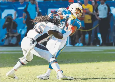  ?? Joe Amon, The Denver Post ?? Broncos linebacker Alexander Johnson stops Los Angeles Chargers running back Austin Ekeler after a short pass play Sunday.