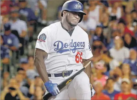  ?? Photograph­s by Luis Sinco Los Angeles Times ?? YASIEL PUIG BREAKS his bat over his knee after striking out in the fifth inning. The Dodgers struck out 13 times and had two hits.