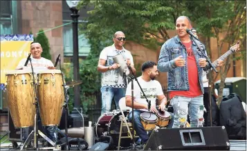  ?? Carol Kaliff / For Hearst Connecticu­t Media ?? Joe Velez, right, and members of his Latin band, perform on the McLevy Green in Bridgeport on Saturday as part of Spanish Heritage Month. More photos on Page A6.