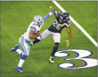  ?? Roger Steinman / Associated Press ?? Dallas Cowboys running back Ezekiel Elliott is defended by Seattle Seahawks cornerback Shaquill Griffin during an NFC wild-card game in Arlington, Texas last Saturday.