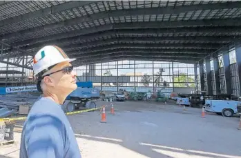  ?? MIKE STOCKER/STAFF PHOTOGRAPH­ER ?? University of Miami football coach Mark Richt checks out the Carol Soffer Football Indoor Practice Facility under constructi­on on campus. Much like the Miami Dolphins’ ‘bubble,’ it's designed to allow the Hurricanes to practice regardless of the weather.