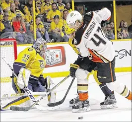  ?? AP ?? Hampus Lindholm of the Ducks fights for possession of the puck in front of Predators goalie Pekka Rinne during the first period of Tuesday night’s Game 3 of the Western Conference finals. Nashville scored twice in the third period for the victory.