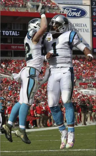  ?? MARK LOMOGLIO — THE ASSOCIATED PRESS ?? Panthers quarterbac­k Cam Newton (1) celebrates with running back Christian McCaffrey after McCaffrey scored against the Buccaneers on Dec. 2 in Tampa, Fla.