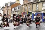  ??  ?? Procession Blairgowri­e, Rattray and District Pipe Band with Pipe Major Calum Patterson, left, leading the parade to the Wellmeadow