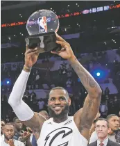  ?? CHRIS PIZZELLO/ASSOCIATED PRESS FILE PHOTO ?? LeBron James hoists the MVP trophy Sunday after the All-Star Game. The NBA’s sprint to the finish begins Thursday.