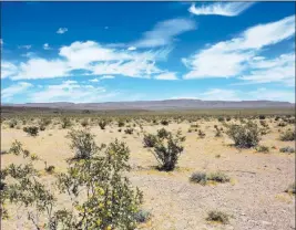  ?? Michael Quine ?? Las Vegas Review-journal @Vegas88s Yucca Mountain, the proposed site for a nuclear waste repository, is seen May 22 from Crater Flat where dormant cinder cone volcanoes dot the desert floor.