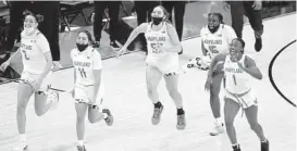  ??  ?? Maryland players celebrate after defeating Iowa in the Big Ten tournament final Saturday in Indianapol­is.