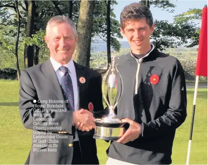  ??  ?? Greg Holmes of (Royal Birkdale GC) is presented with the Lancashire County Boys Championsh­ip trophy by Lancashire Union of Golf Clubs President Dr Steven Reid