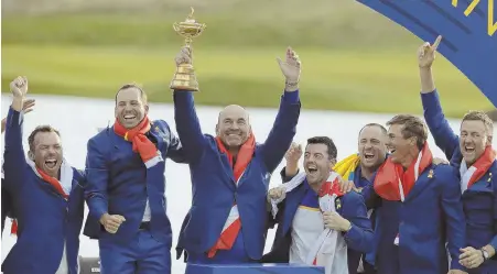  ??  ?? CUP RUNNETH OVER: Europe team captain Thomas Bjorn holds the trophy aloft as he celebrates with his team after they beat the United States to capture the 42nd Ryder Cup yesterday at Le Golf National outside Paris. AP PHOTO