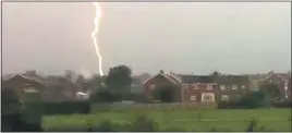  ??  ?? As the heatwave breaks, a massive bolt of lightning hits the TV aerial of a family home in East Boldon, Tyne and Wear
