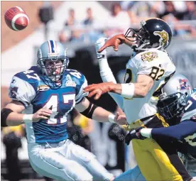  ?? CANADIAN PRESS FILE PHOTO ?? Tiger-Cats receiver Darren Flutie has the ball knocked out of his hands during a week-after-Labour-Day game in Montreal in 1999, where the Alouettes laid a 52-19 drubbing on the Ticats. That came after a Labour Day win against Toronto.