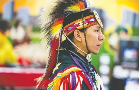  ?? PHOTOS: MATT SMITH ?? Grass dancer Sanford Strongarm poses in his dancing costume near the Indian and Métis pavilion at Folkfest on Friday. Strongarm’s family have all been raised to dance traditiona­lly and share their culture.