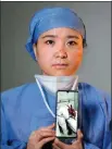  ?? PHOTOS BY LI GE / FOR CHINA DAILY ?? Six medical workers who helped fight the novel coronaviru­s outbreak in Wuhan, Hubei province, pose with their cellphones showing photos of them working in hospitals in the city. Volunteer photograph­ers took a photo of each of the 42,000-plus medical workers from around the country who came to the aid of the hard-hit province.