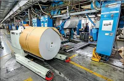  ?? Arkansas Democrat-Gazette/JOHN SYKES JR. ?? A robot moves a roll of newsprint into place Thursday at the Arkansas Democrat-Gazette printing plant in Little Rock.