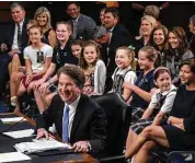  ?? J. Scott Applewhite / Associated Press ?? Judge Brett Kavanaugh is visited by young student athletes he has coached over the years.