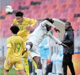  ?? /MICHAEL SHEEHAN/GALLO IMAGES ?? Thabani Austin Dube of Bafana heads the ball away during the Cosafa Cup match against Senegal at Nelson Mandela Bay Stadium in Gqeberha.