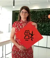  ??  ?? Elisabeth Staudinger, president of Siemens Healthinee­rs Asia Pacific, shows an example of her calligraph­y. The Chinese character fu (fortune) is mostly seen during Spring Festival signifying happiness to come.