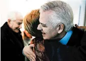  ?? CAROLYN VAN HOUTEN/THE WASHINGTON POST ?? Keith Allred and Carolyn Lukensmeye­r hug after a discussion on civility and partisansh­ip Friday in Washington.