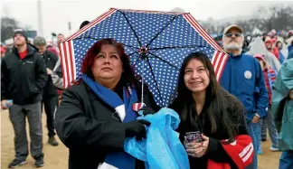  ?? REUTERS ?? Supporters of US President Donald Trump watch his inaugurati­on from their vantage point at the National Mall in Washington.