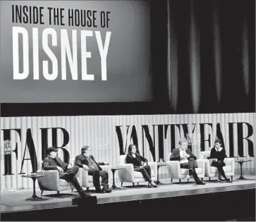  ?? Michael Kovac ?? DISNEY’S GROWTH during CEO Robert Iger’s reign atop the company has been fueled in part by the purchase of content-focused firms. Above, Iger, second from right, at a conference in San Francisco this month.