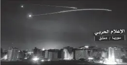  ??  ?? An image released by the government-affiliated ‘Central War Media’ in Syria purportedl­y shows Syrian air defence systems intercepti­ng Israeli missiles over Damascus' airspace. Israel strikes on Syria kill at least 23 fighters Israeli strikes on several...