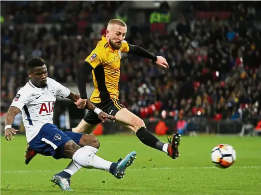  ??  ?? Going all out: Tottenham’s Serge Aurier (left) attempts a shot at goal as Newport’s Dan Butler tries to defend during the English FA Cup fourthroun­d replay at Wembley on Wednesday. — AP
