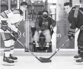  ?? CONTRIBUTE­D ?? As part of the Make a Wish game last month, Brayden Cream, who had his wish in 2013, drops the puck between Truro Major U-15 Bearcats captain Matt Merryweath­er (right) and Dartmouth Whalers captain Jacob Rhyno.