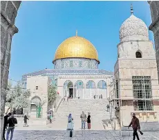  ??  ?? People walk towards the Dome of the Rock at the Aqsa Mosque compound, Islam’s third holiest site, in the old city of Jerusalem on the eve of the Muslim holy fasting month of Ramadan..