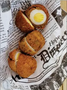  ?? PHOTO BY EMILY RYAN ?? This Scotch egg sampler features one of each – traditiona­l, jerk chicken and chorizo.