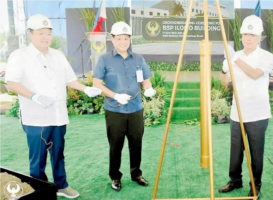  ?? PHOTOGRAPH COURTESY OF BSP ?? BSP to have Iloilo office Bangko Sentral ng Pilipinas (BSP) Governor Felipe Medalla (rightmost) recently led the groundbrea­king ceremonies for the BSP’s new building at the Iloilo Business Park in Mandurriao, Iloilo City. Medalla said once completed, the new building will enhance the accessibil­ity and efficiency of BSP services in Western Visayas. Medalla sets up the time capsule with Iloilo City Mayor Jerry Treñas (left) and Iloilo Governor Arthur Defensor Jr. during the groundbrea­king ceremonies.