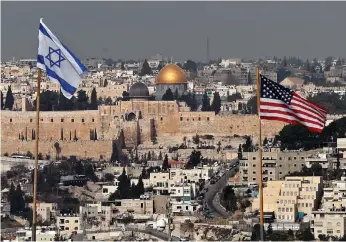  ??  ?? Israeli and US flags on the roof of an Israeli settlement building in East Jerusalem last month