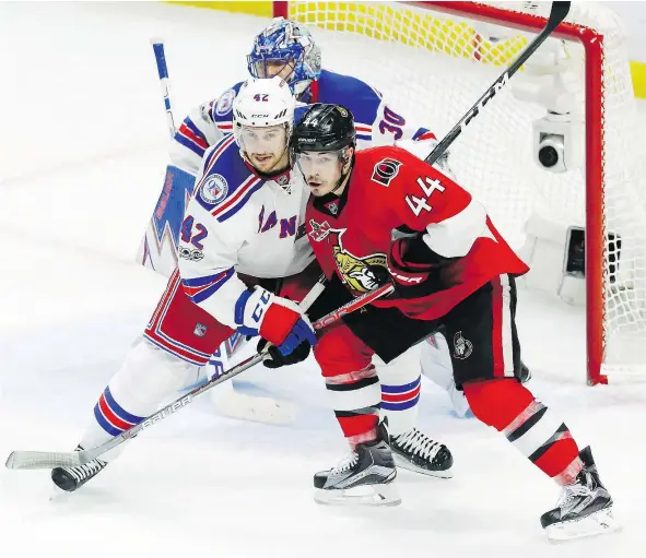  ?? — THE CANADIAN PRESS FILES ?? Ottawa Senators centre Jean-Gabriel Pageau, seen battling with New York Rangers defenceman Brendan Smith in front of goaltender Henrik Lundqvist on Saturday in Ottawa, got four goals in the game, including the tying and winning tallies.